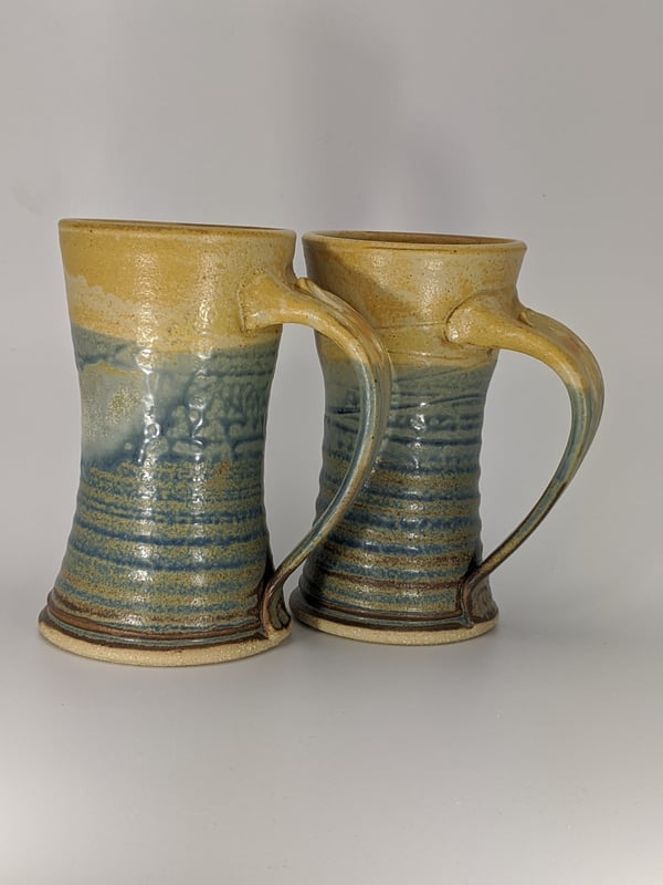 Image of Pair of blue and orange steins