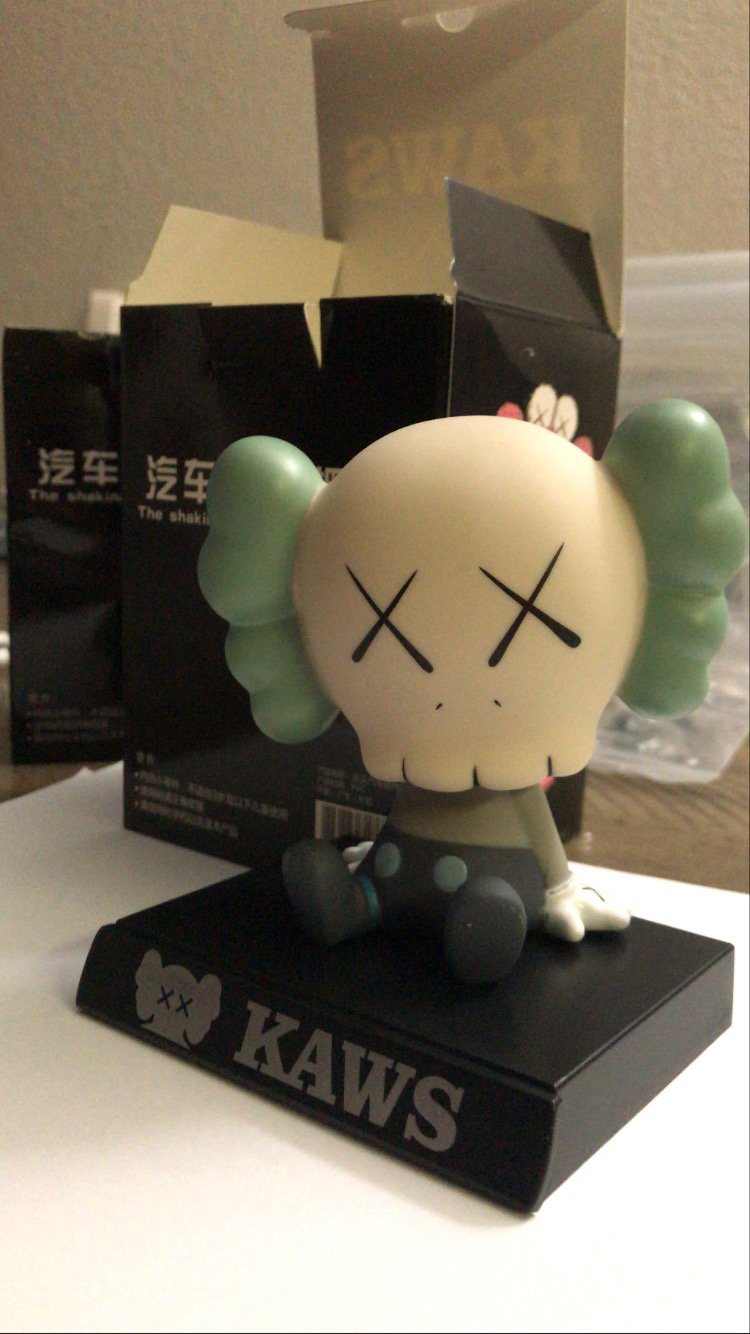 Image of teal kaws bobble head