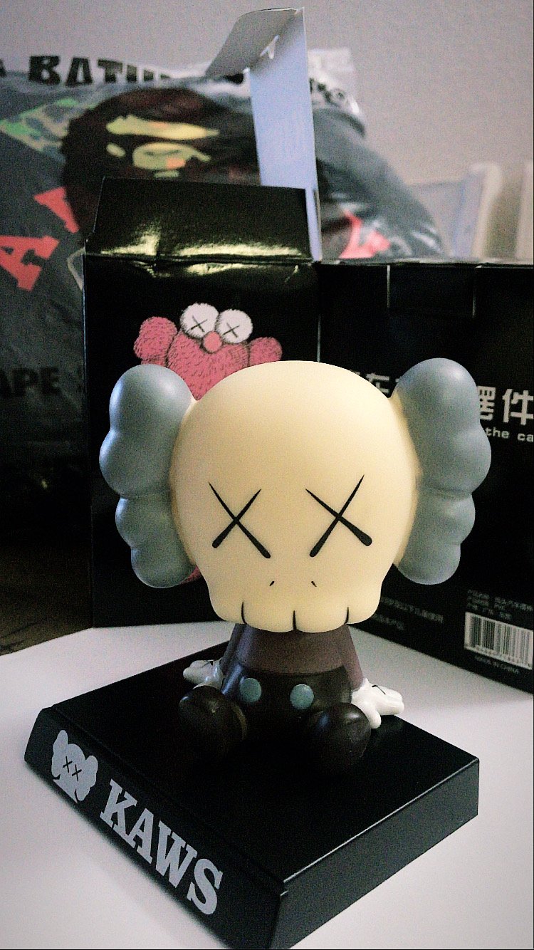Image of grey kaws bobble head