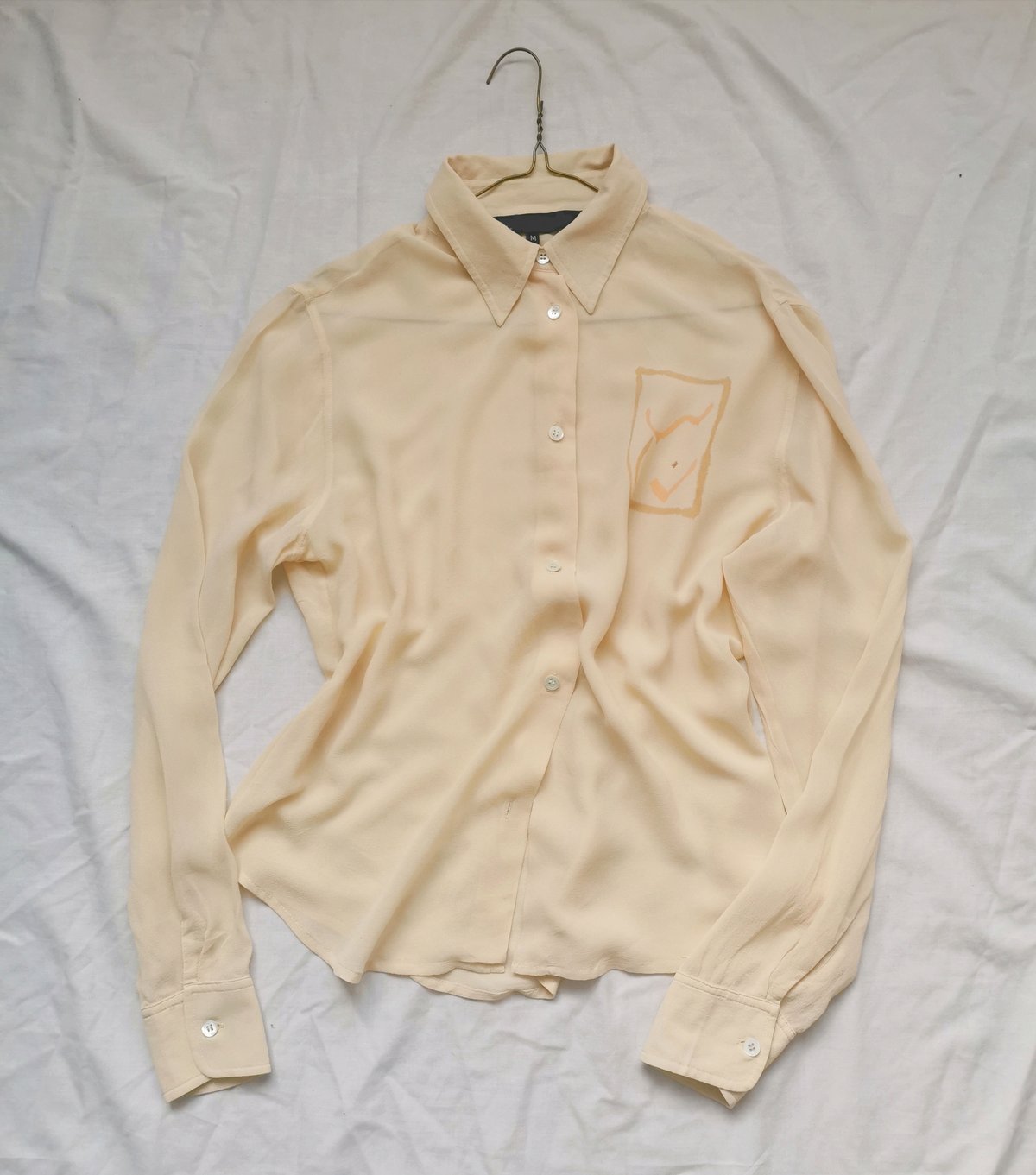 Image of pale gold blouse