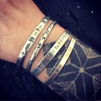 Image 3 of 'Luna' symbol stamped cuff bracelet. Slim silver Aztec patterned cuff bracelet. 