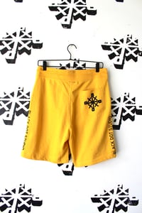 Image of right in the middle shorts in yellow 