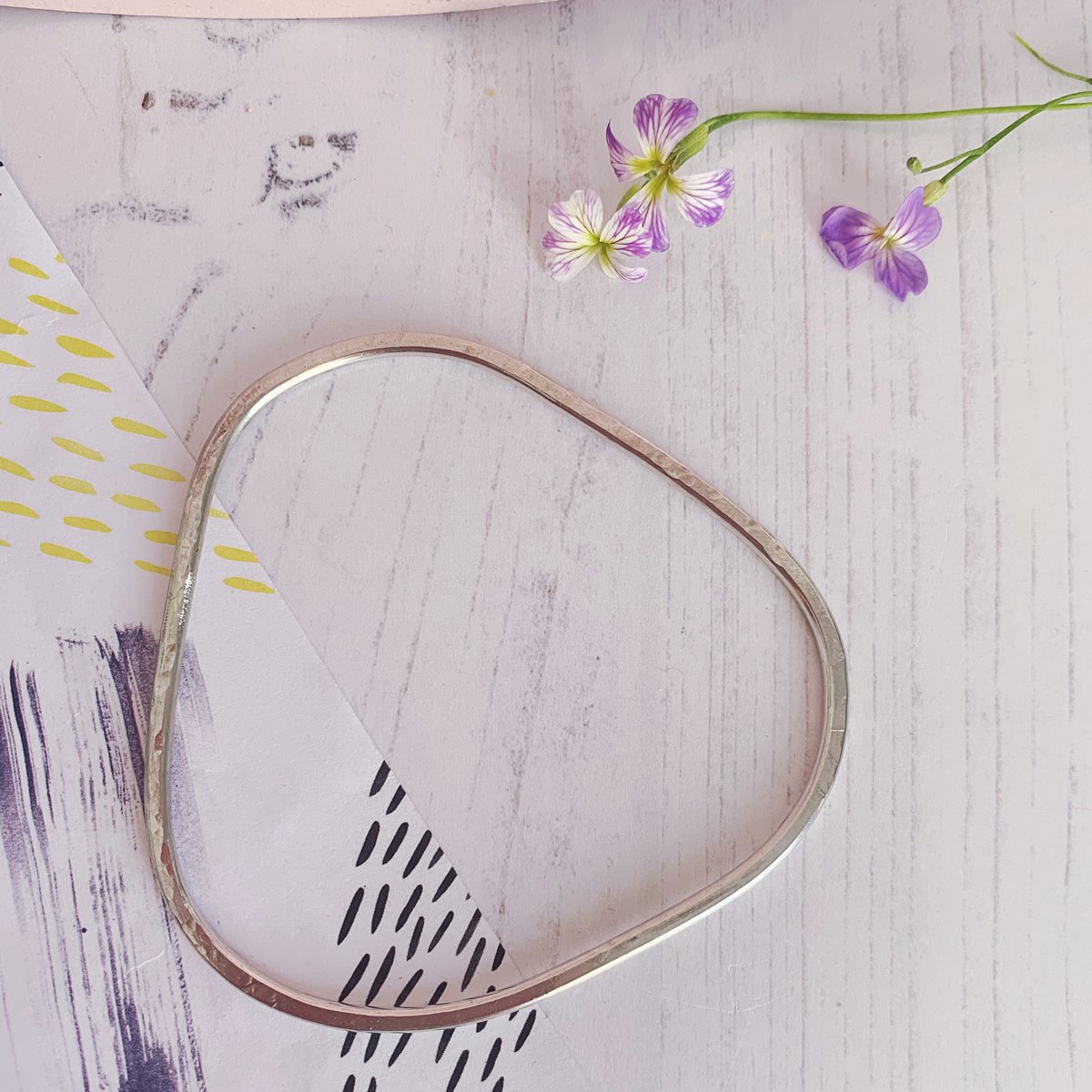 Image of Recycled sterling silver triangle bangle with hammered texture.