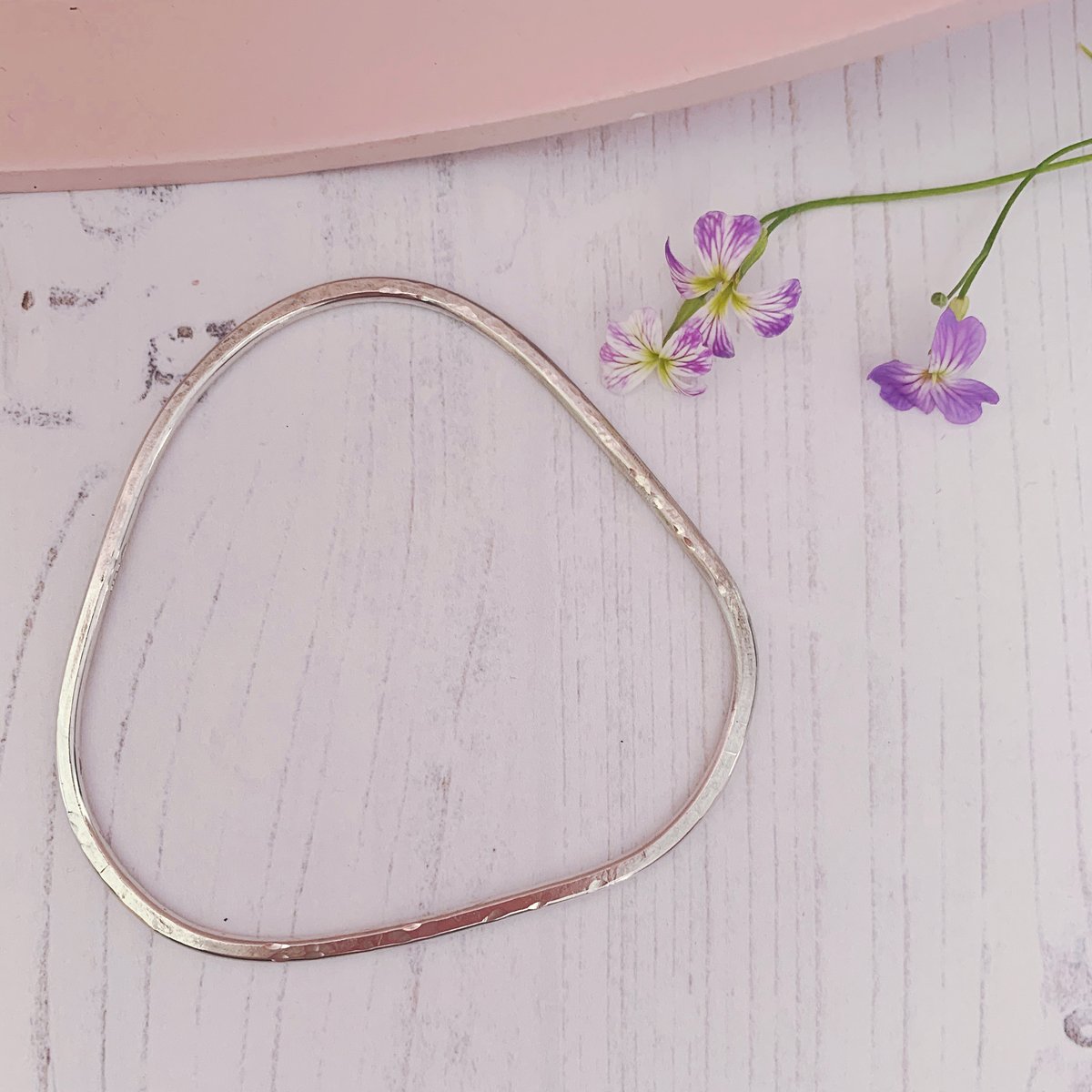 Image of Recycled sterling silver triangle bangle with hammered texture.