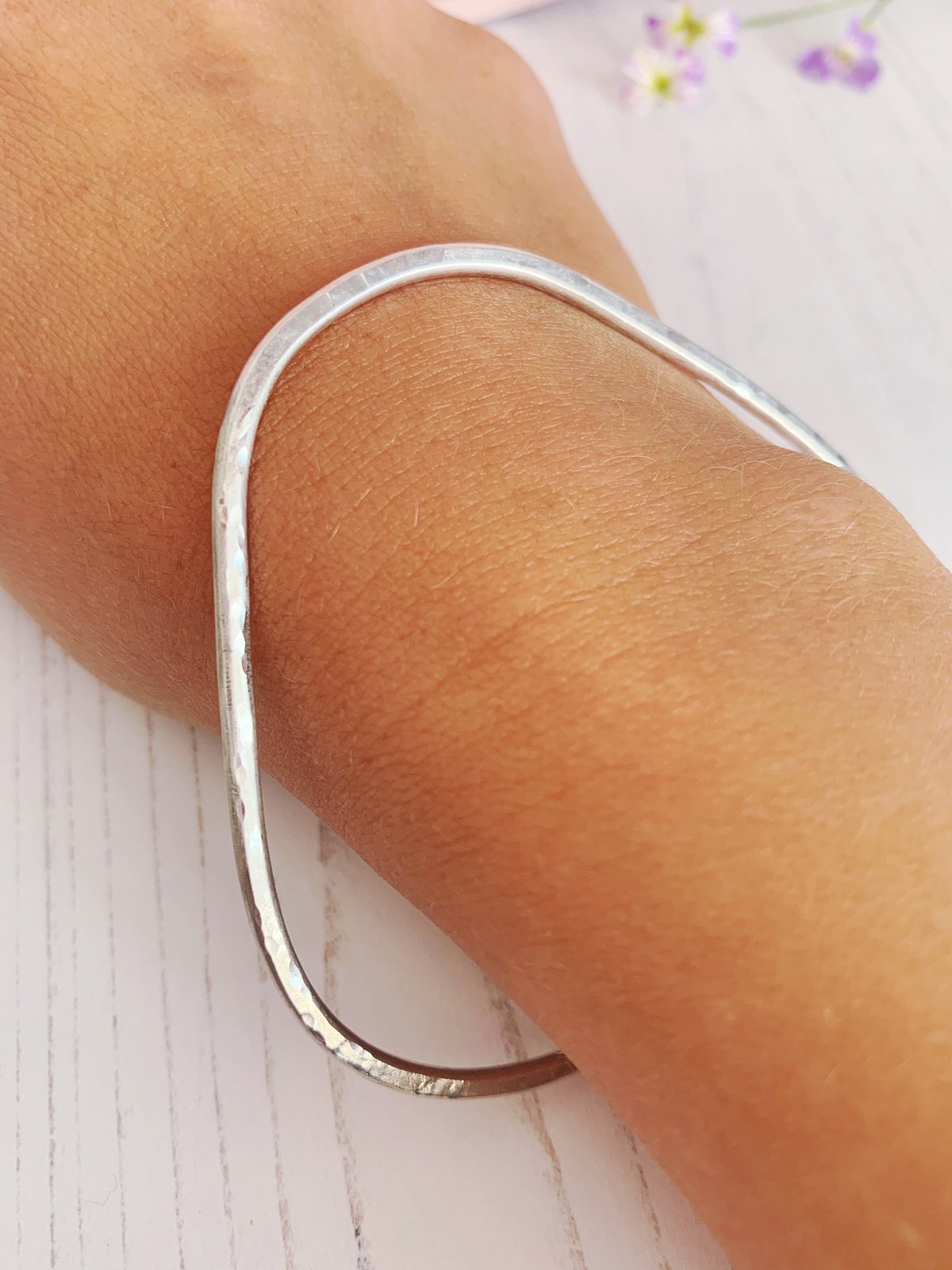 Image of Recycled sterling silver triangle bangle with hammered texture. 