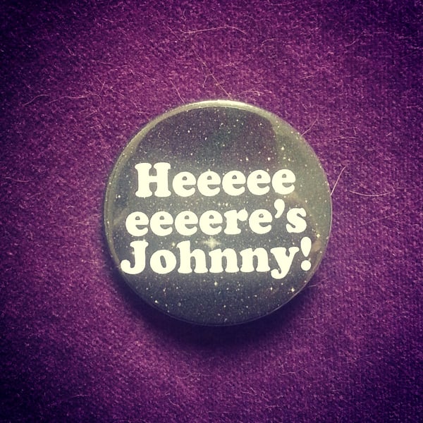 Image of badge shinning - here's johnny