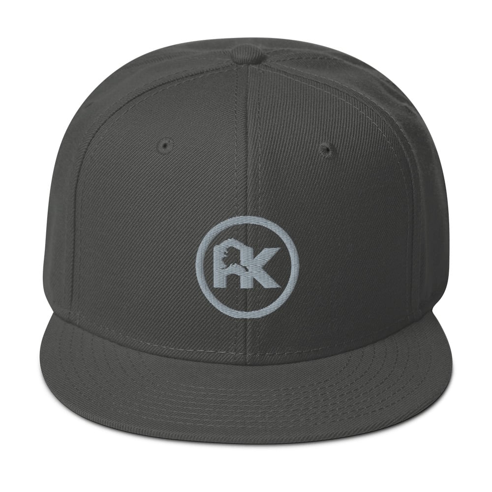 Image of CJAK logo - Gray on Charcoal Gray