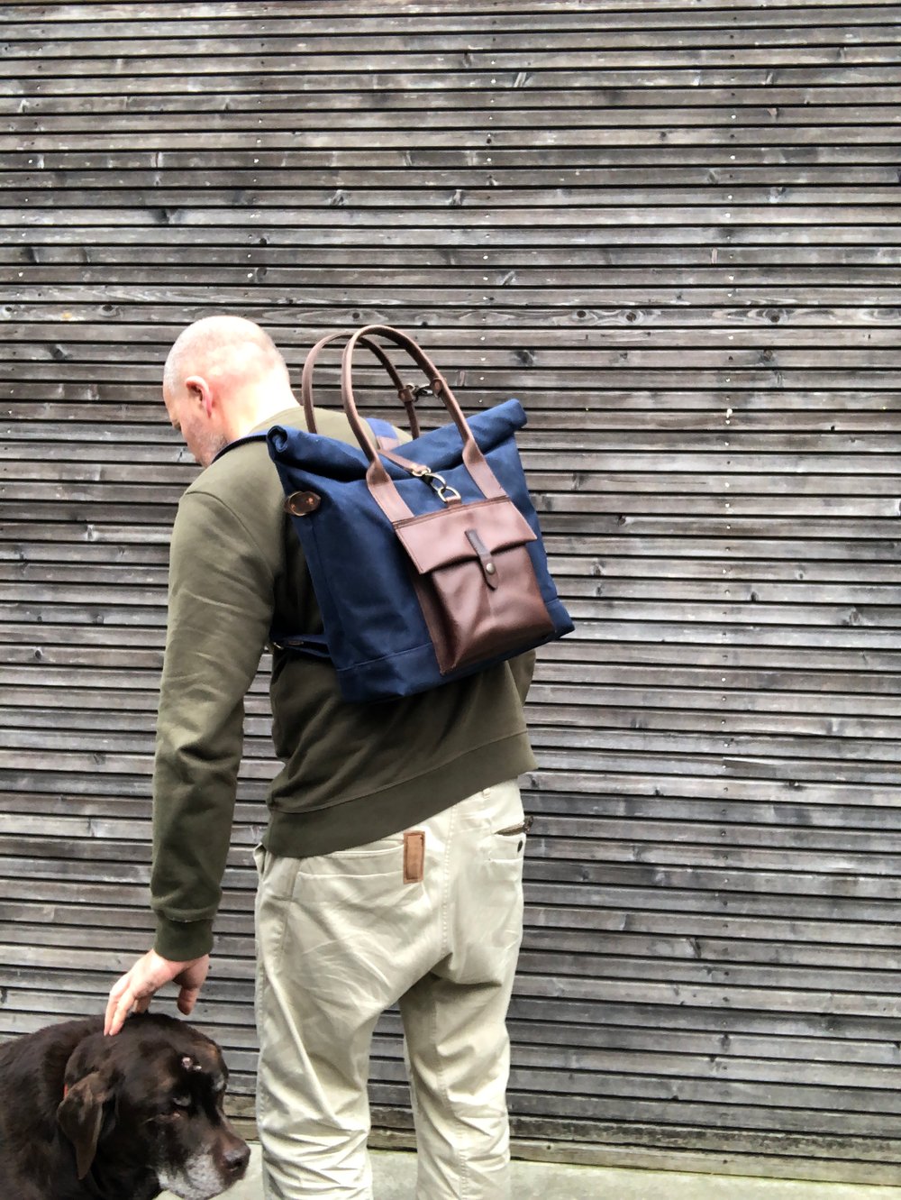 Image of Convertible backpack in waxed canvas with leather outside pocket and cross body strap