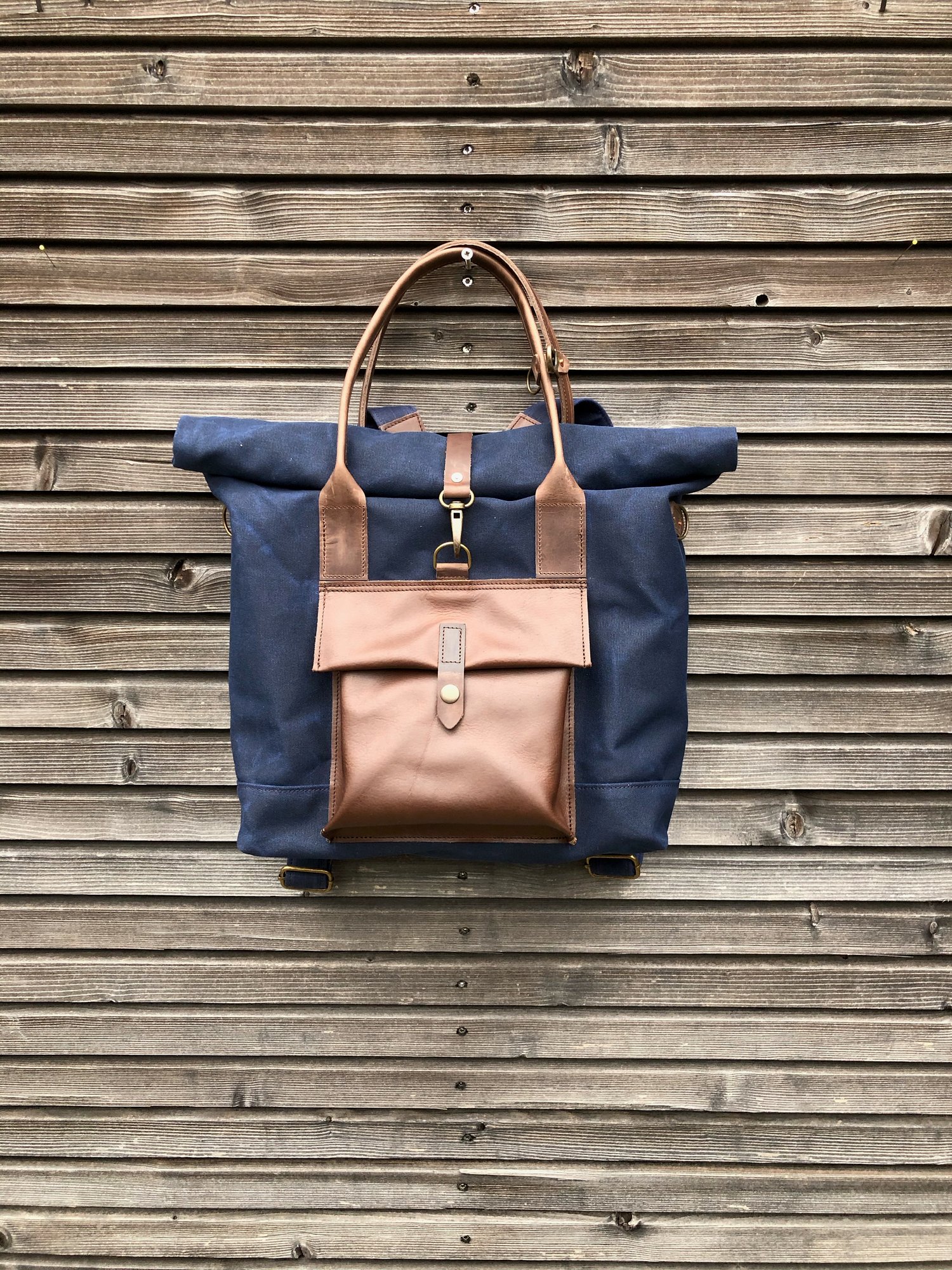 Image of Convertible backpack in waxed canvas with leather outside pocket and cross body strap