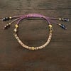 purple EVOLUTION REVOLUTION bracelet
