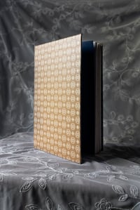 Oatmeal journal with white design and navy endpages