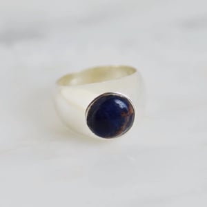 Image of Sodalite cabochon cut solid frame silver signet ring