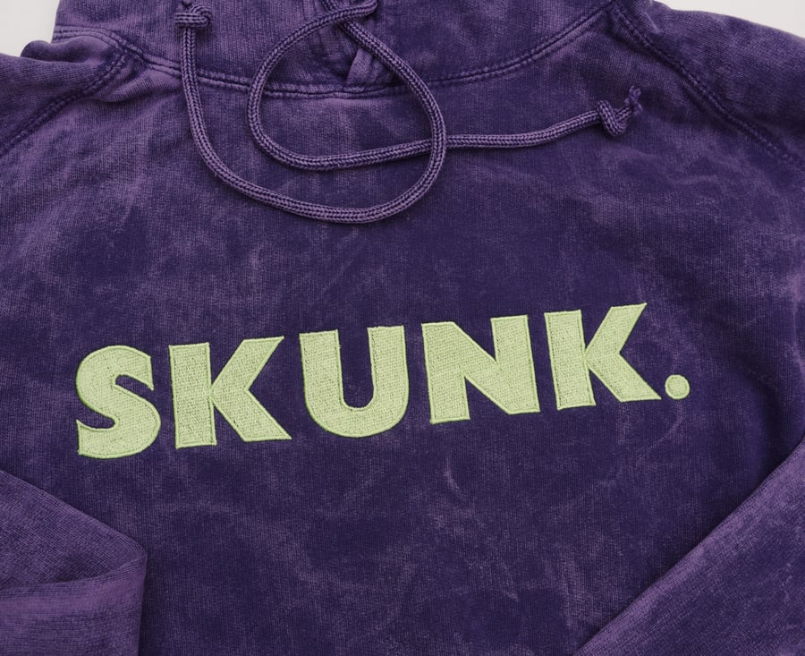 Image of "Skunk." Hoodie (purple/slimegreen)