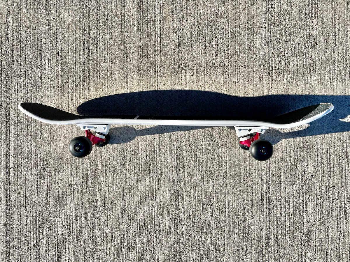 Image of White Complete Skateboard w/ Metallic Red Trucks