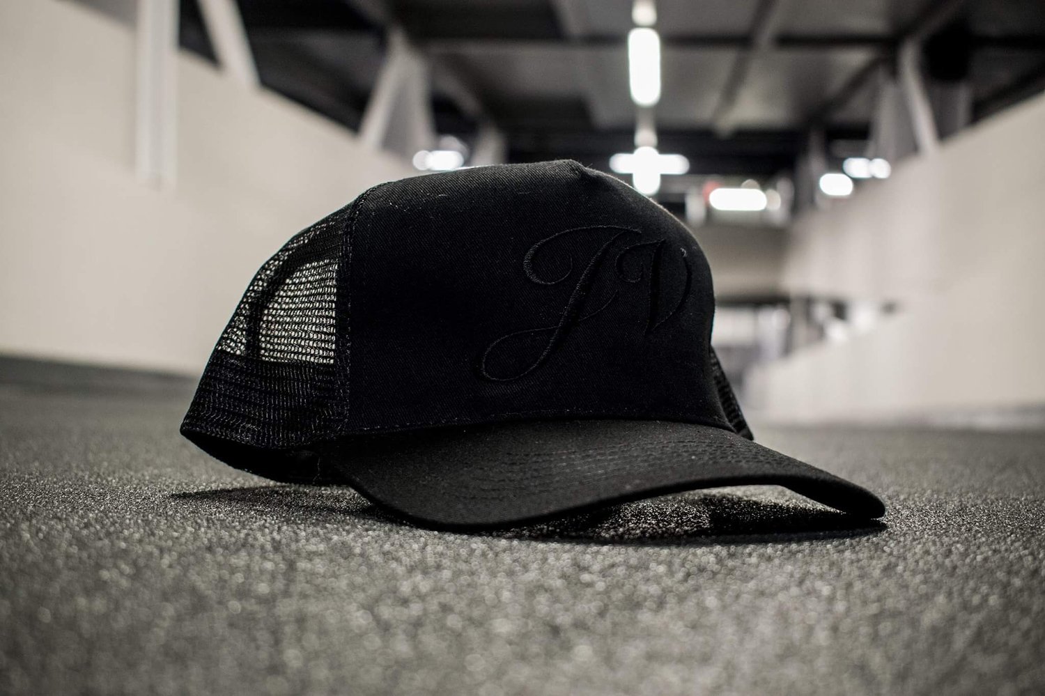 Image of JV Unisex All Black Mesh Trucker Cap