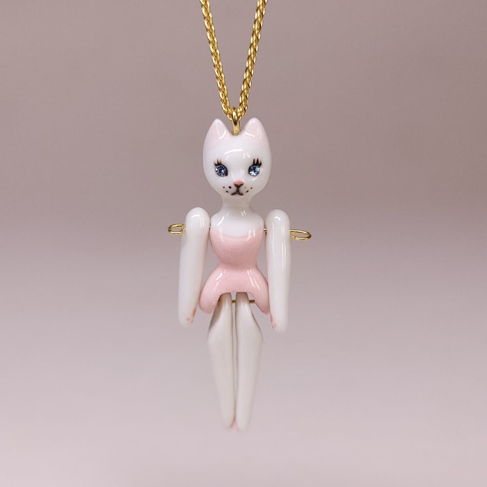 Image of White Porcelain & Gold Vermeil Articulated Doll Pendant