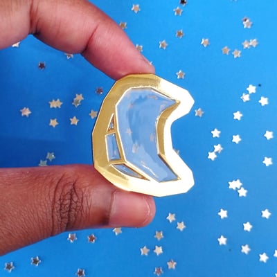 Image of glass moon enamel pin
