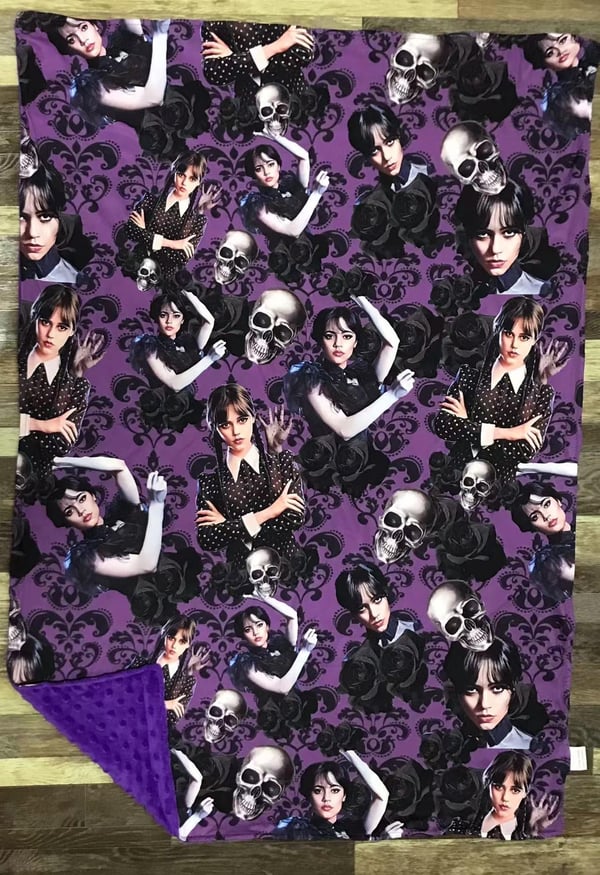 Image of Purple Wednesday adams with skull blanket 