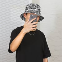 Image 1 of "Reversible Australian flowers and skull" bucket hat