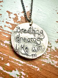 Image 2 of blue sapphire pendant with Fitzgerald quote