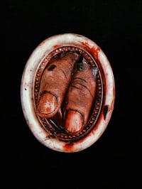 Image 1 of Severed Thumbs in White Oval Frame 