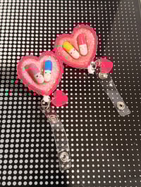 Image 1 of happy pills badge reel 