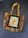  shoulder bag in leopard fabric with Virgin of Guadalupe patch and black or gold fringing