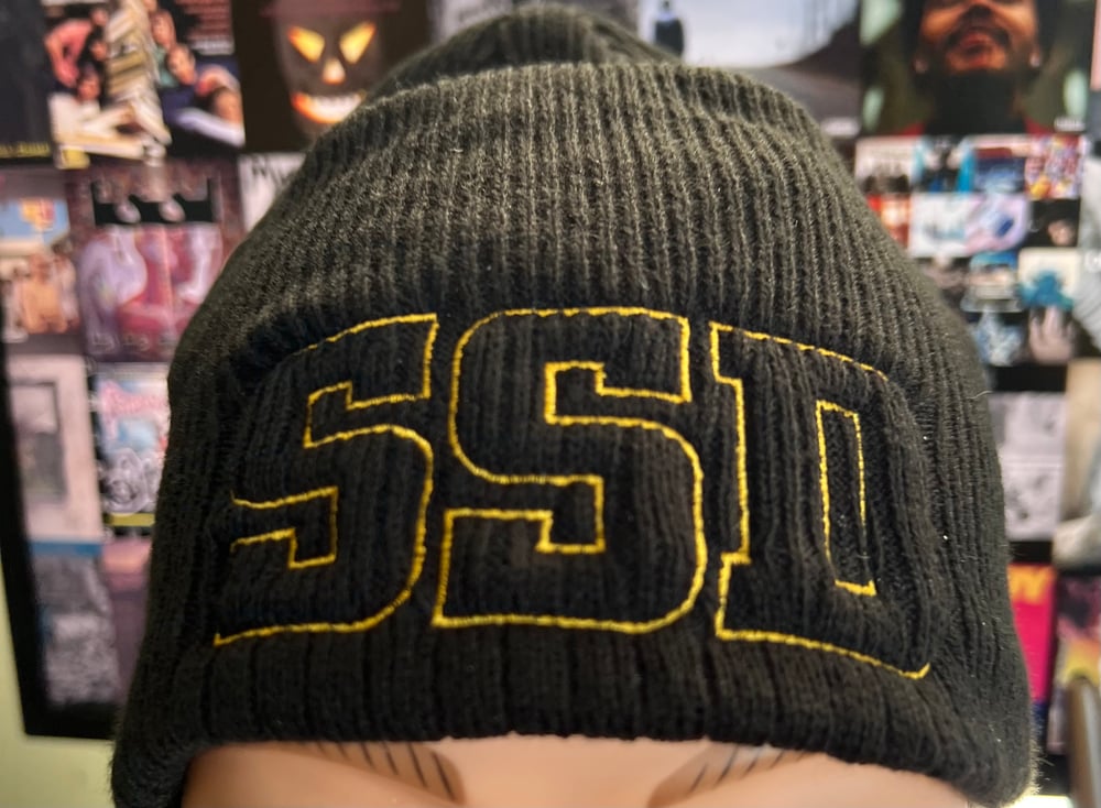Black New Era Knit beanie hat with Gold Outline SSD logo 