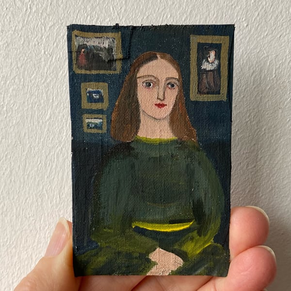 Image of Woman in green with paintings - tiny portrait 