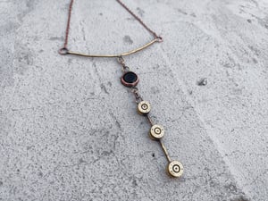 3 bullet casings and black stone necklace 