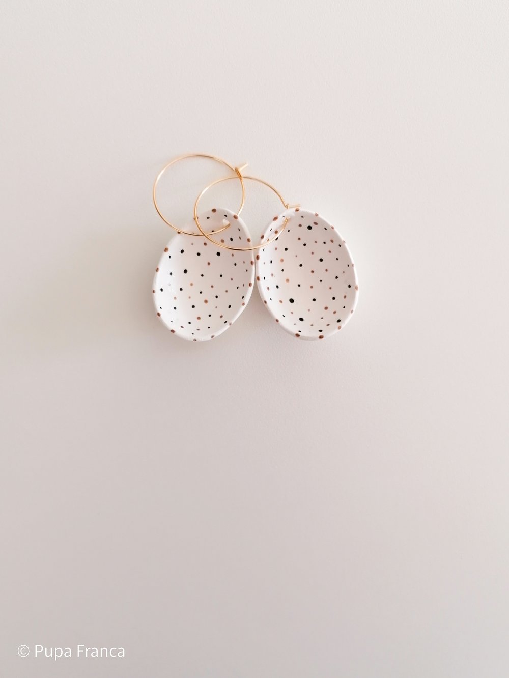Image of Eggshell Earrings with Black and Golden dots