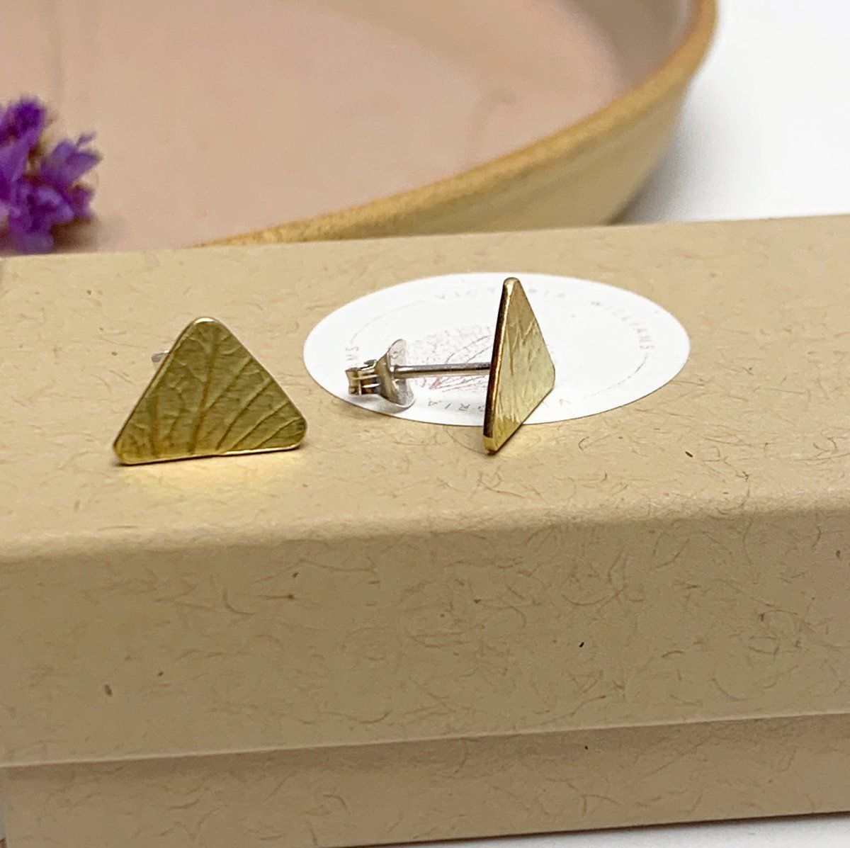 Image of Brass triangle studs with petal imprint.