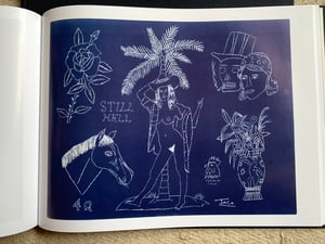 Image of The Blue Book tattooing flash catalog. 