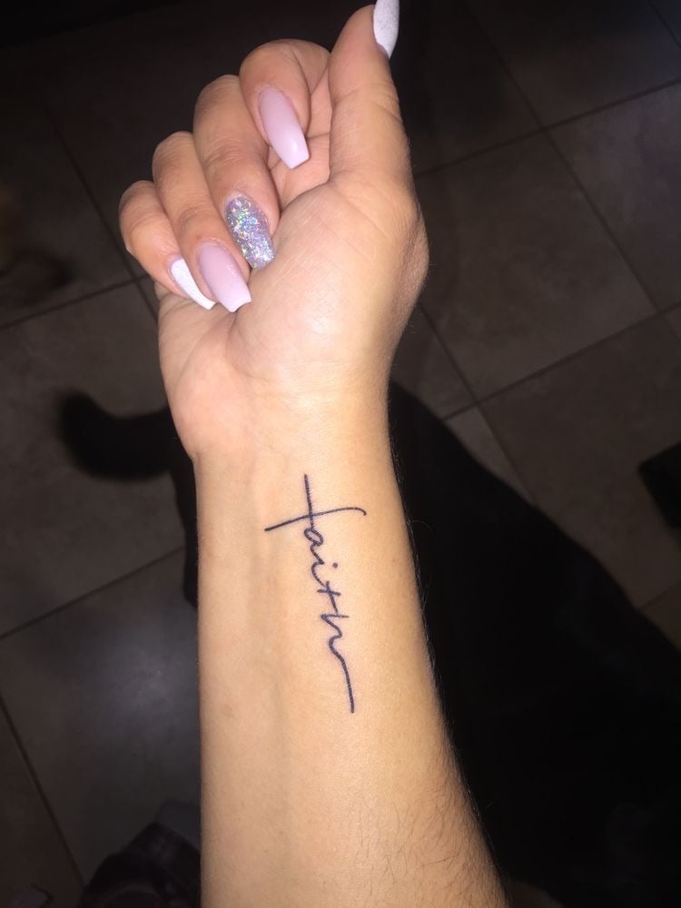 faith tattoo on forearm