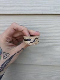 Image 1 of Red Snake Bone Slice