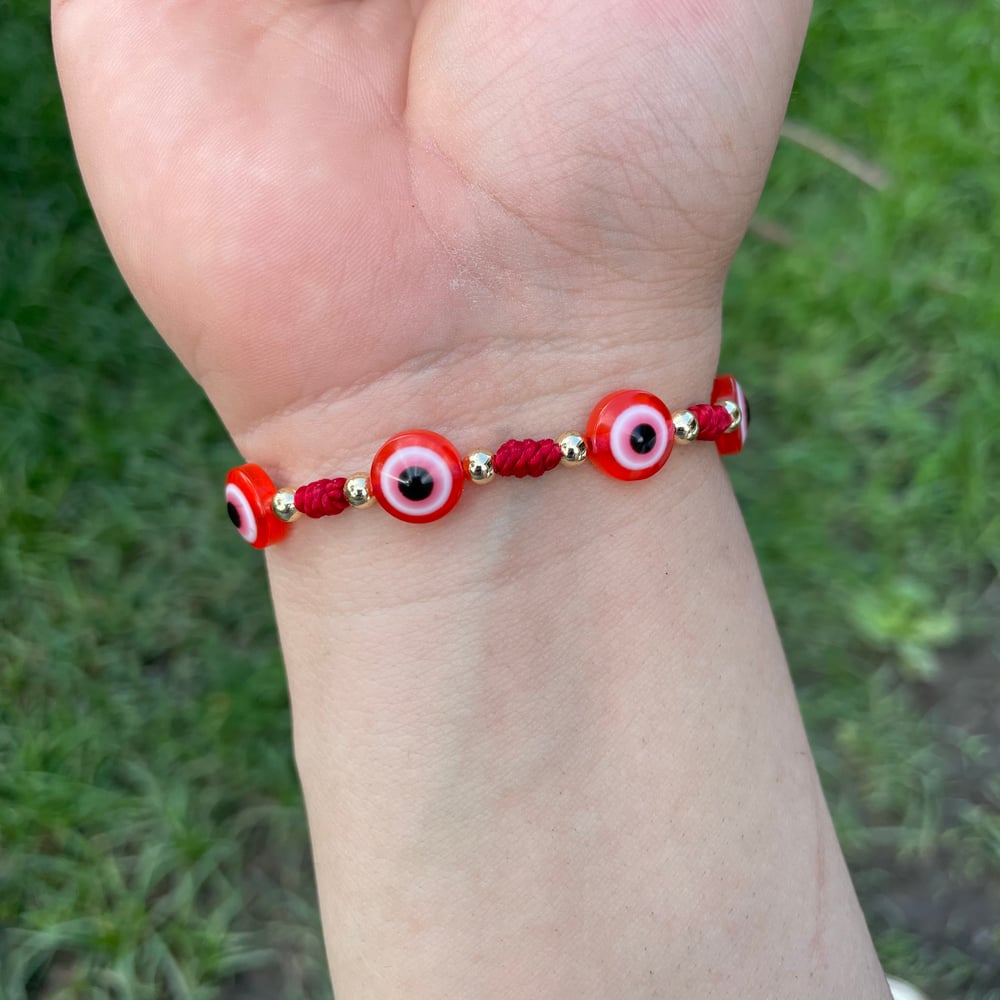 7 knot bracelet with evil eyes