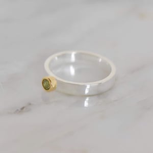 Image of Peridot round cut 18k gold plated framed x silver band ring