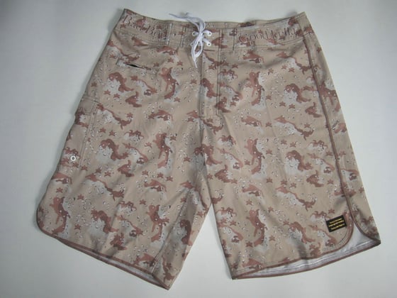 Image of Slicksymbol logo brown camo boardshorts