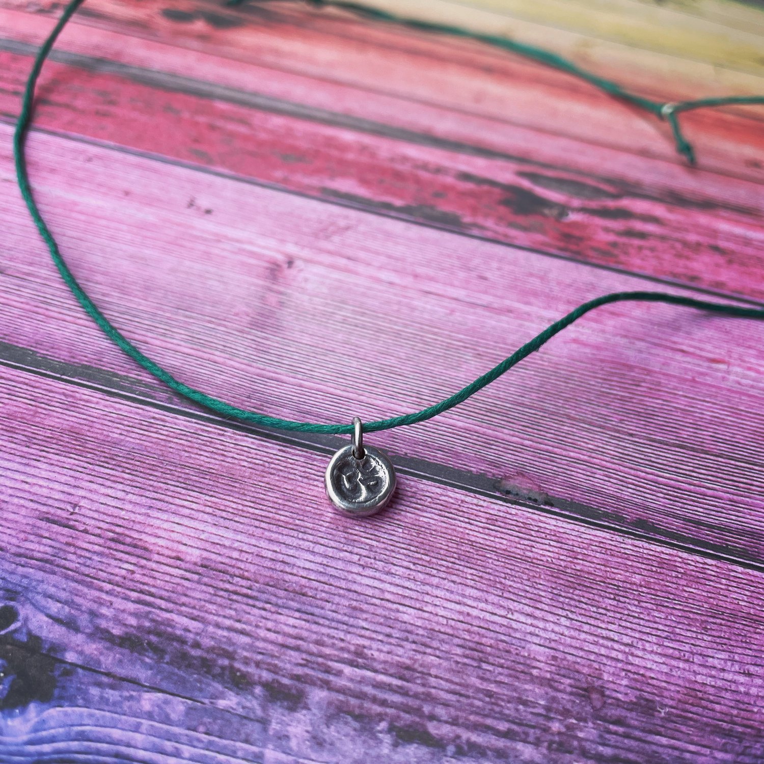 Image of Om / Aum charm necklace. Handmade silver charm, waxed hemp cord adjustable yoga necklace