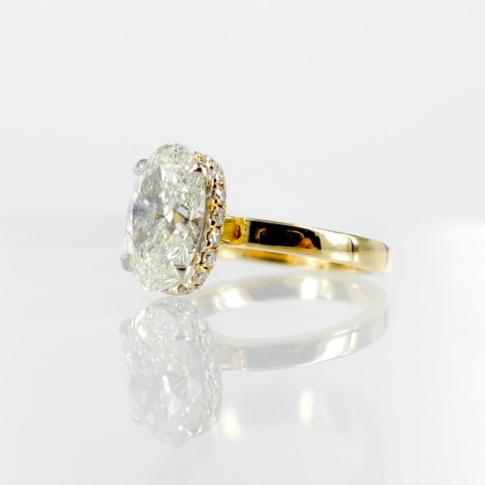 Image of 18ct yellow gold halo oval diamond engagement ring. Pj5685