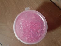 Small container of pink glitter slime