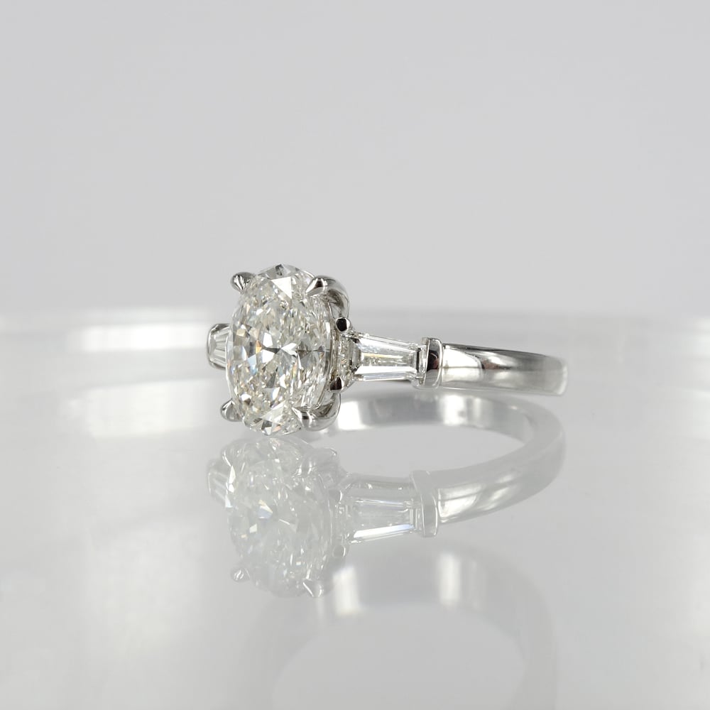 Image of Stunning 18ct white gold oval + baguette diamond ring. PJ5811