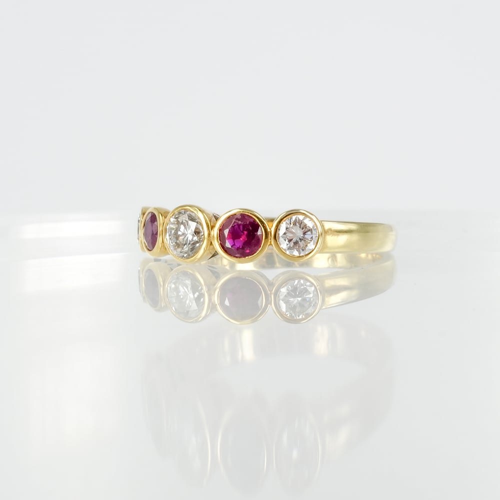 Image of 18ct yellow gold bezel set diamond and garnet dress ring. 