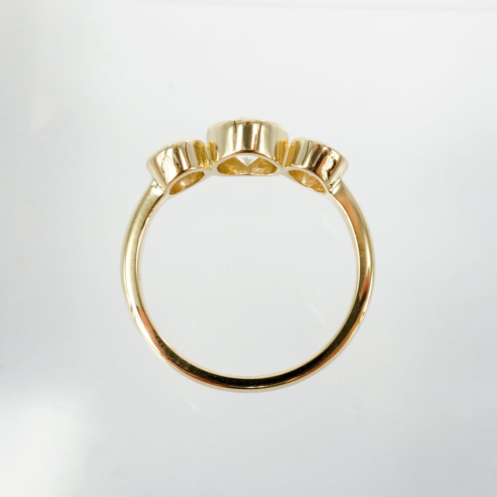 Image of 18ct yellow gold bezel set trilogy ring. PJ5790