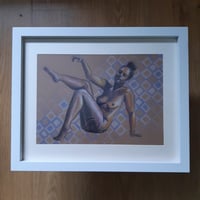 Reclining figure with blue and white squares