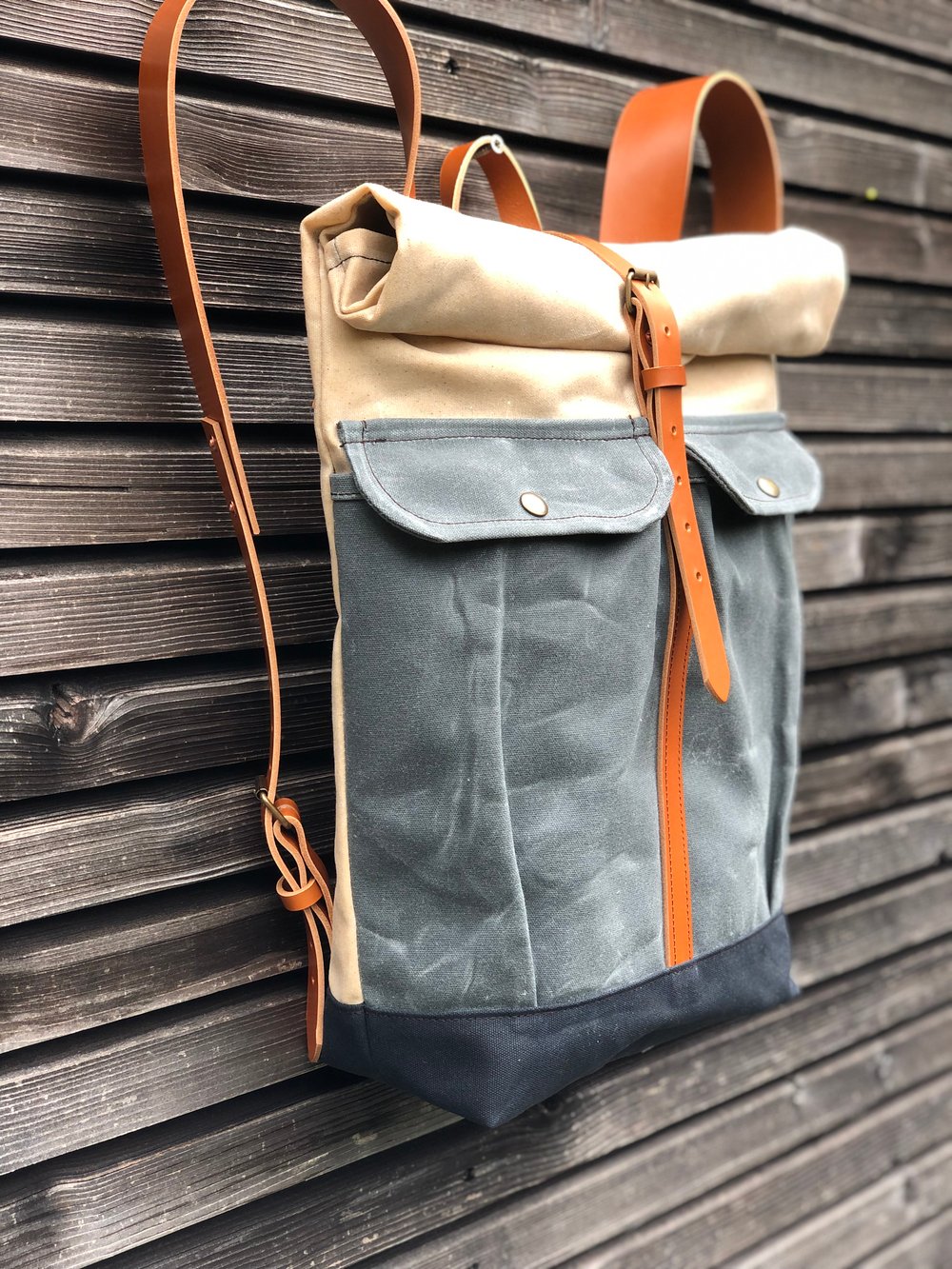 Waxed canvas rucksack with roll to close top and vegetable tanned