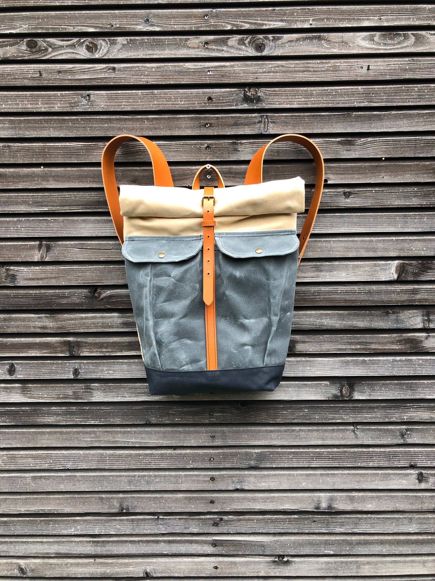 Waxed canvas rucksack with roll to close top and vegetable tanned ...