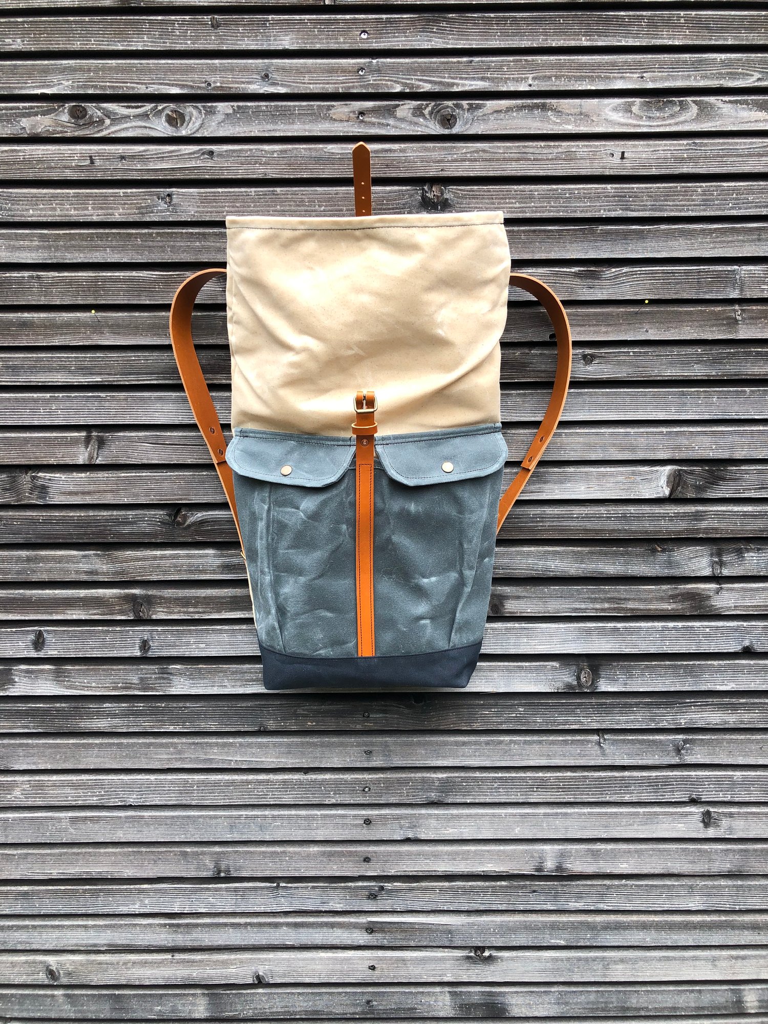 Image of Waxed canvas rucksack with roll to close top and vegetable tanned leather shoulder straps