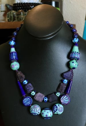 Lapis River - junk drawer necklace featuring loads of lampwork and sugilite