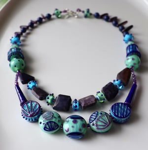 Lapis River - junk drawer necklace featuring loads of lampwork and sugilite